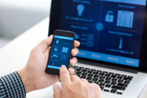 man holding phone with program smart home on the screen